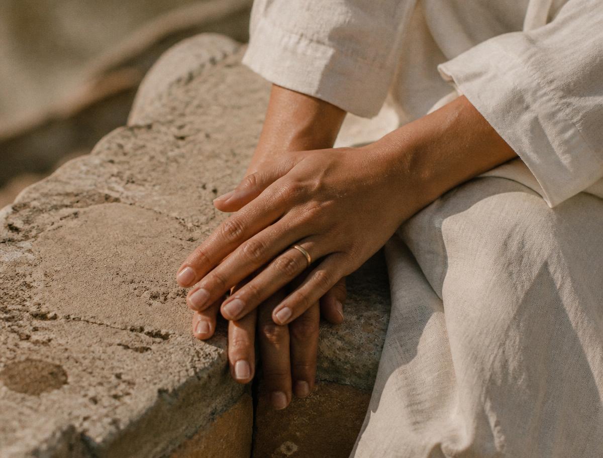Hands resting on warm stone